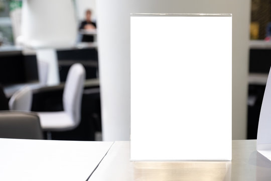 Mock up Menu frame in Bar restaurant ,Stand for booklets with white sheets of paper acrylic tent card on wooden table on
