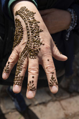 A Henna artist applies her trade to a client in Chefchaouen, Morocco