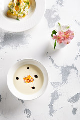 Exquisite Serving White Cream Soup with Pumpkin and Salmon