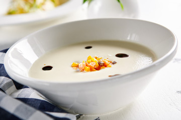 Exquisite Serving White Cream Soup with Pumpkin and Salmon