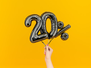 Twenty percent symbol discount. 20 % sale banner black flying foil balloons on yellow. 3d rendering.