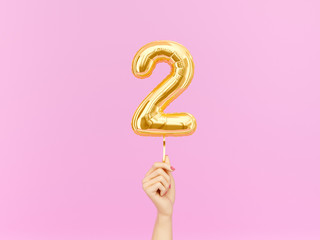 Two year birthday. Female hand holding Number 2 foil balloon. Two-year anniversary background. 3d rendering - obrazy, fototapety, plakaty