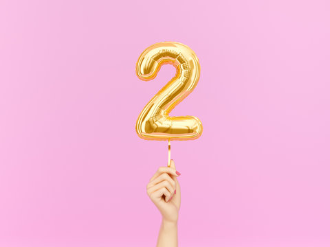 Two year birthday. Female hand holding Number 2 foil balloon. Two-year anniversary background. 3d rendering