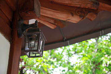 a lantern hanging from the eaves of a traditional Korean house.
