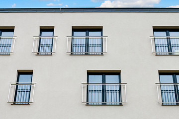 Block of flats facade with windows.
