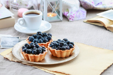Blueberries cake and cup of coffee.