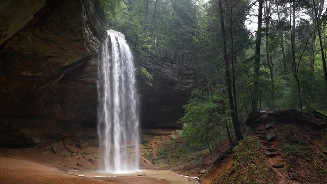 Ash Cave Falls Loop - Ash Cave, an enormous recess cave in the Hocking Hills of Ohio, is graced by a plunging waterfall in this seamlessly looping footage.
