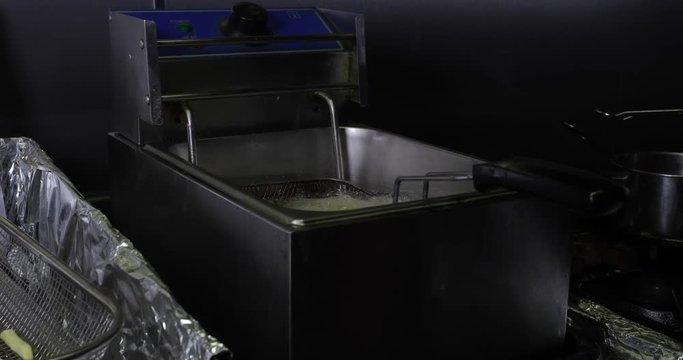 Reverse Slow Motion Shot Putting Potato Fries/Chips In Hot Oil To Fry - 4K 30fps