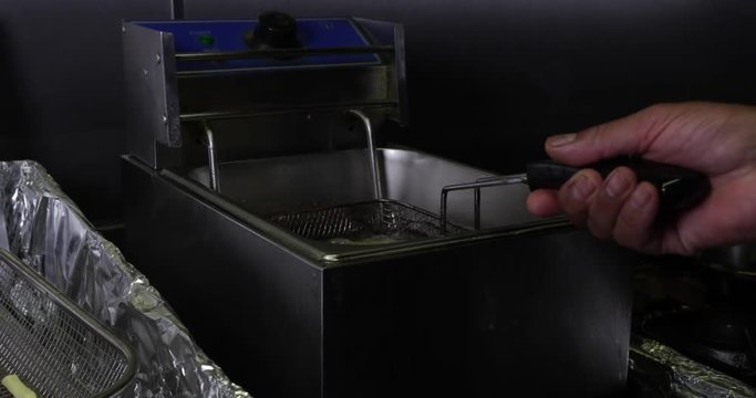 Slow Motion Shot Putting Potato Fries/Chips In Hot Oil To Fry - 4K 30fps