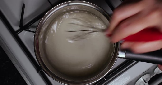 Lady Mixing Water And Sugar In A Pan To Make Caramel 4K 30FPS - Cooking, Boiling, Sweet