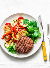 Grilled beef cutlet and vegetables - delicious healthy balanced lunch on a light background, top view
