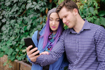 Couple doing selfie on phone. Friends drinking coffee on a break.