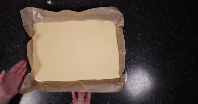 Reverse Shot Of Lady Showing Finished Raw Batter Ready To Be Put Into Oven 4K 30FPS - Oven, Hot, Baking, Tray
