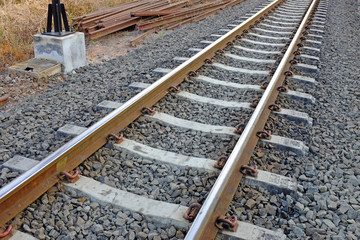 Steel support rails with concrete sleepers strewn with gravel 