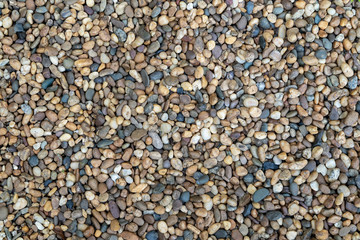 Abstract background from pebbles pattern on ground. Nature backdrop.