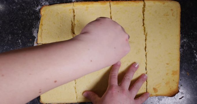 Reverse Clip Of Lady Using Pizza Cutter To Cut Across Plain Cake In Order To Shape It Into Squares To Fill With Egg Cream 4K 30FPS - Flour, Sugar, Sweet, Shaped