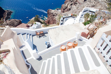 beautiful Oia town on Santorini island, Greece. Traditional white architecture and greek orthodox churches with blue domes over the Caldera, Aegean sea. Scenic travel background