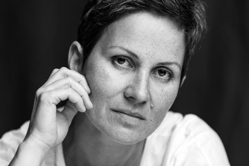 Middle-aged woman with a short haircut without makeup, close-up. Caulk face. Black and white...