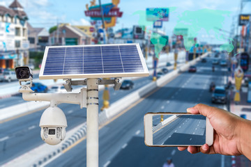 Person look CCTV by smart phone .Solar cells panel is use solar energy with Speed dome camera and...