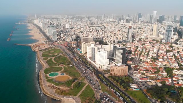 Aerial view of flight above Tel Aviv, Israel with city skyline. Epic shot over sea shore. Amazing aerial shot. flight of drone over public beach in tel Aviv district of Jaffa. top view, aerial view