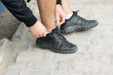 Person putting on pair of shoes.