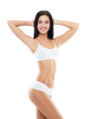 Fototapeta premium Young, fit and beautiful brunette girl in white swimsuit.