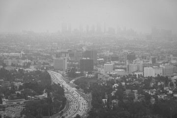 Black & white hazy cityscape view from the Hollywood Bowl Overlook on Mulholland Drive, in Los Angeles, California