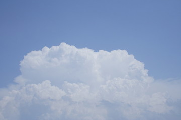 Gigantic columns of clouds rose in the summer sky.