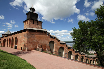 Fototapeta premium View of Clock tower and a wall of the Kremlin under the blue sky with beautiful white clouds