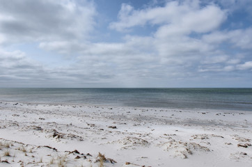 Sand beach at the coast of Baltic sea under cloudy sky