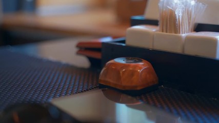 Close up hand pressing the bell button to call the waiter. Close-up female hand presses waiter call button. - Powered by Adobe