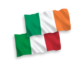 National vector fabric wave flags of Italy and Ireland isolated on white background. 1 to 2 proportion.