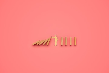 Paper cut silhouette of a man stopping falling dominos