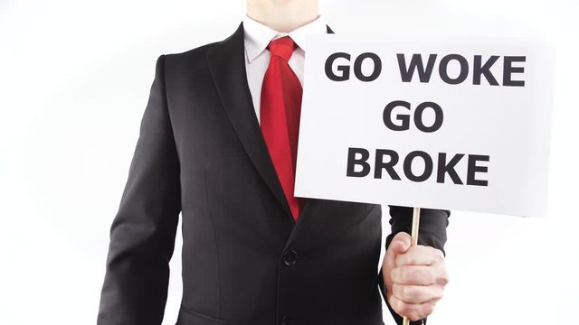 Red tie business person hold sign Go Woke Go Broke 4K