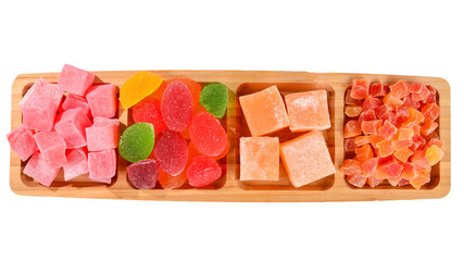 Wooden plate with cashew, marmalade and sweet turkish delight. Isolated on white background. Space for text or design.