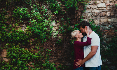 Young affectionate couple standing and hugging outdoors. Copy space. Bilder und Videos suchen: gegenseitig