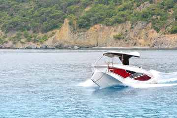 Fototapeta premium Speedy motorboat goes by the sea
