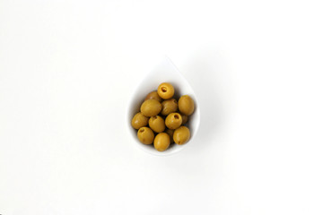 Olives without pits in a white plate isolated on white background, horizontal photo