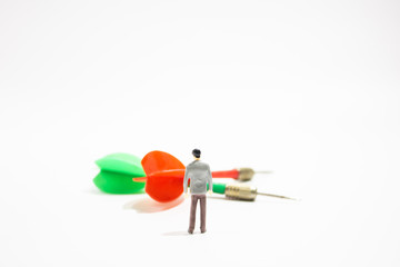 miniature business people with dart isolated white background. decision concept.
