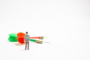 miniature business people with dart isolated white background. decision concept.