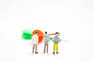 a group of miniature business people with dart isolated white background. decision concept.