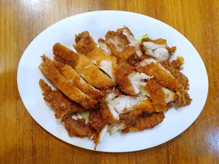Top view of fried chicken breast in white plate on wooden table, Ready to eat or serve