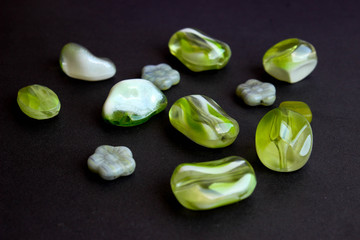 different beads scattered on a black background