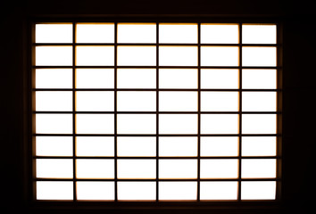 Lights shining into the room from the shoji screen window. Japanese architecture for door or window for room divider.