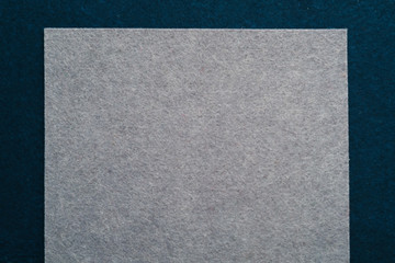 Fototapeta premium Gray felt texture layer over dark teal blue abstract art background. Geometric collage. Empty space.