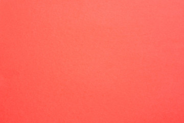 Coral red felt texture abstract art background. Solid color carton surface. Empty space.
