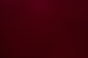 Burgundy red felt texture abstract art background. Solid color construction paper surface. Copy...