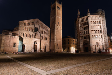 Night view of Parma's Duomo and Baptistery in Piazza Duomo, illuminated by street lights