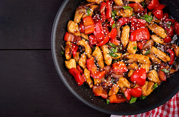 Stir fry chicken, sweet peppers and green onion. Top view. Asian cuisine