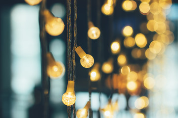 Abstract blurred of blue and silver glittering shine bulbs lights background. Christmas wallpaper decorations concept. Xmas holiday festival backdrop